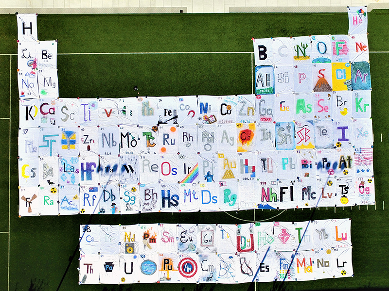 In celebration of both the International Year of the Periodic Table in 2019 and National Chemistry Week, students from two chemistry organizations unfurled a 100-foot-tall, 135-foot-wide handmade periodic table on Buckley Field.